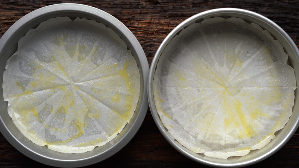 Cake pans with parchment paper and nonstick cooking spray.