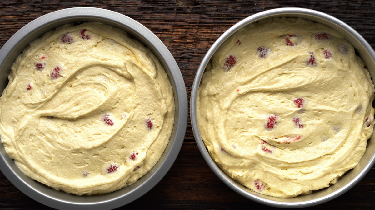 Cake batter in cake pans.
