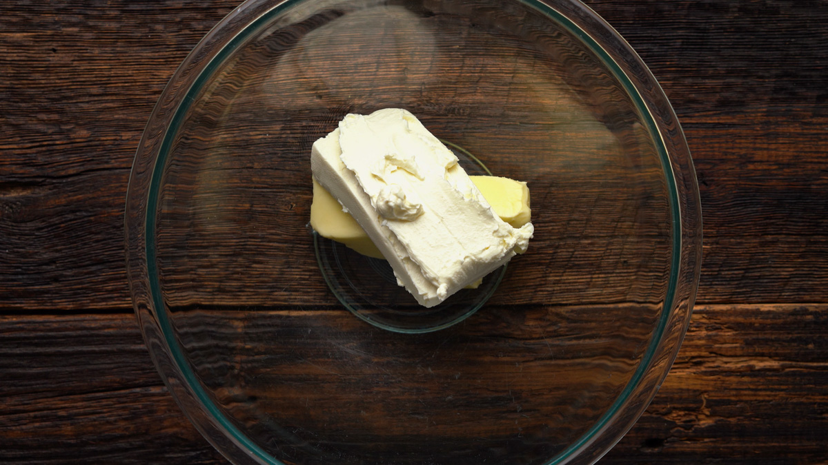 Butter and cream cheese in a glass bowl.