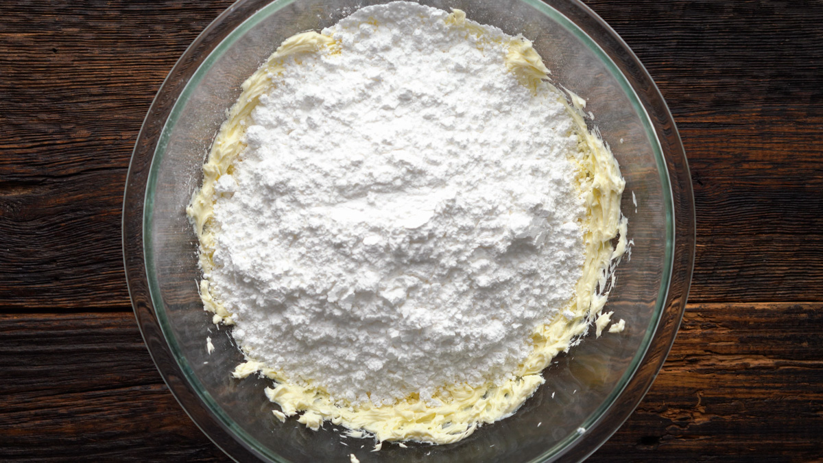 Powdered sugar added into a glass bowl.