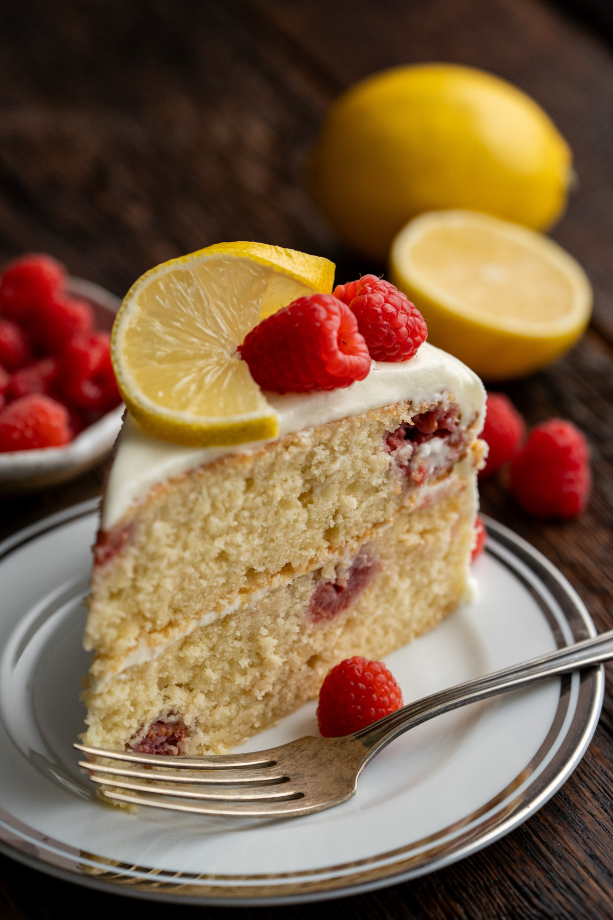 Slice of lemon raspberry cake on a white plate.