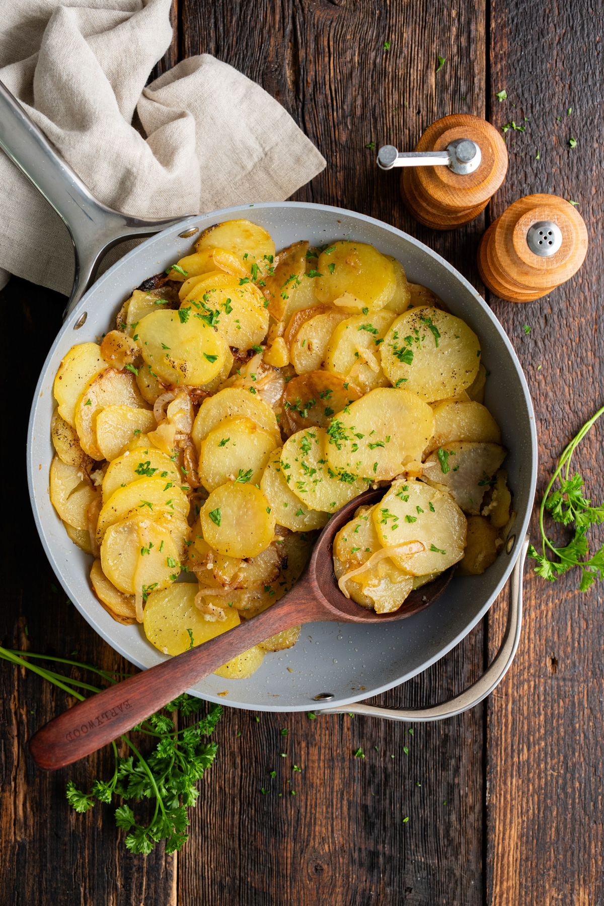 Skillet filled with smothered potatoes.