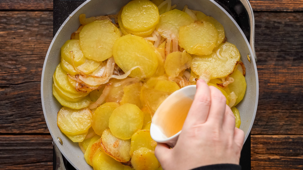 Broth added into the skillet.
