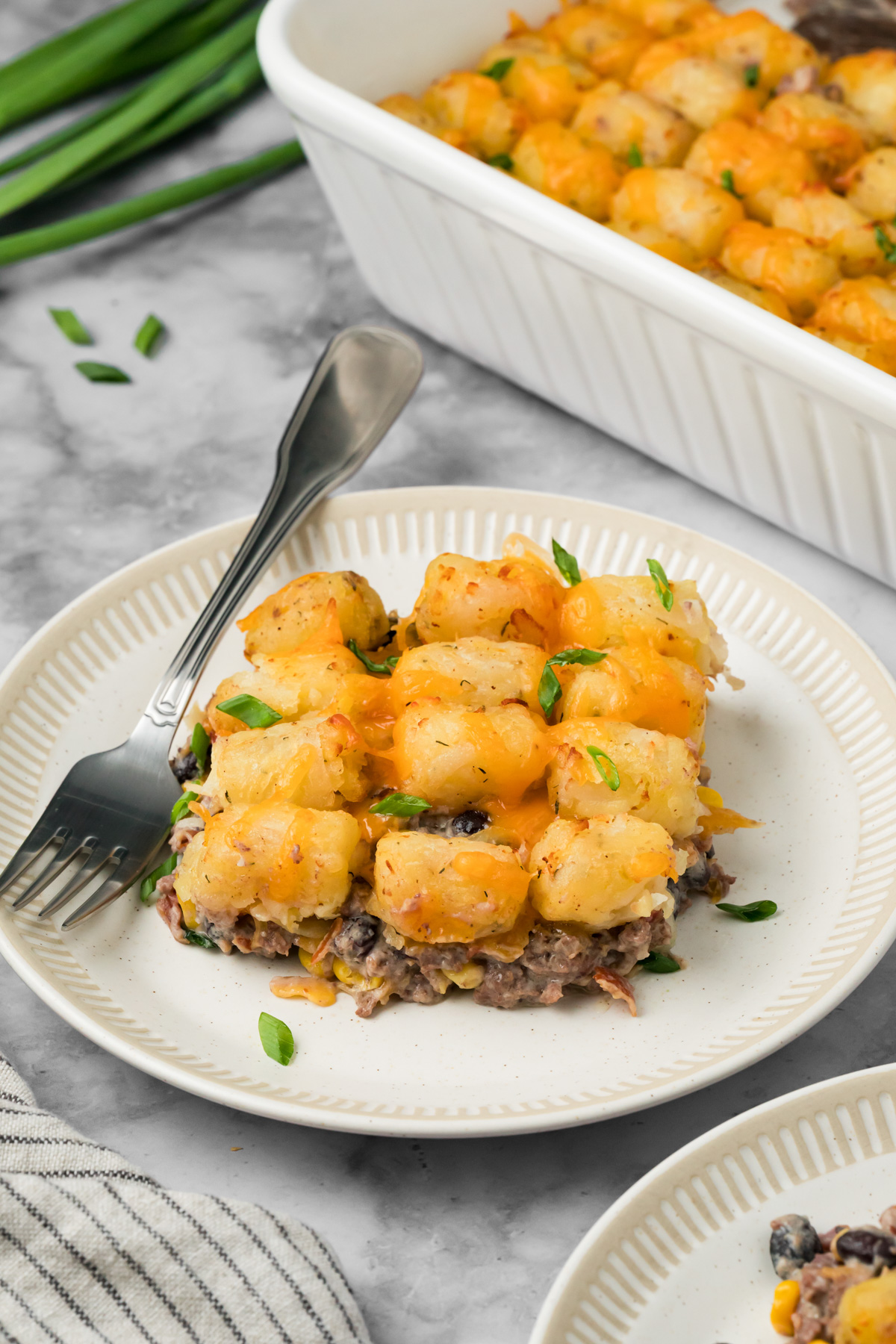 A serving of cowboy casserole on a white plate.