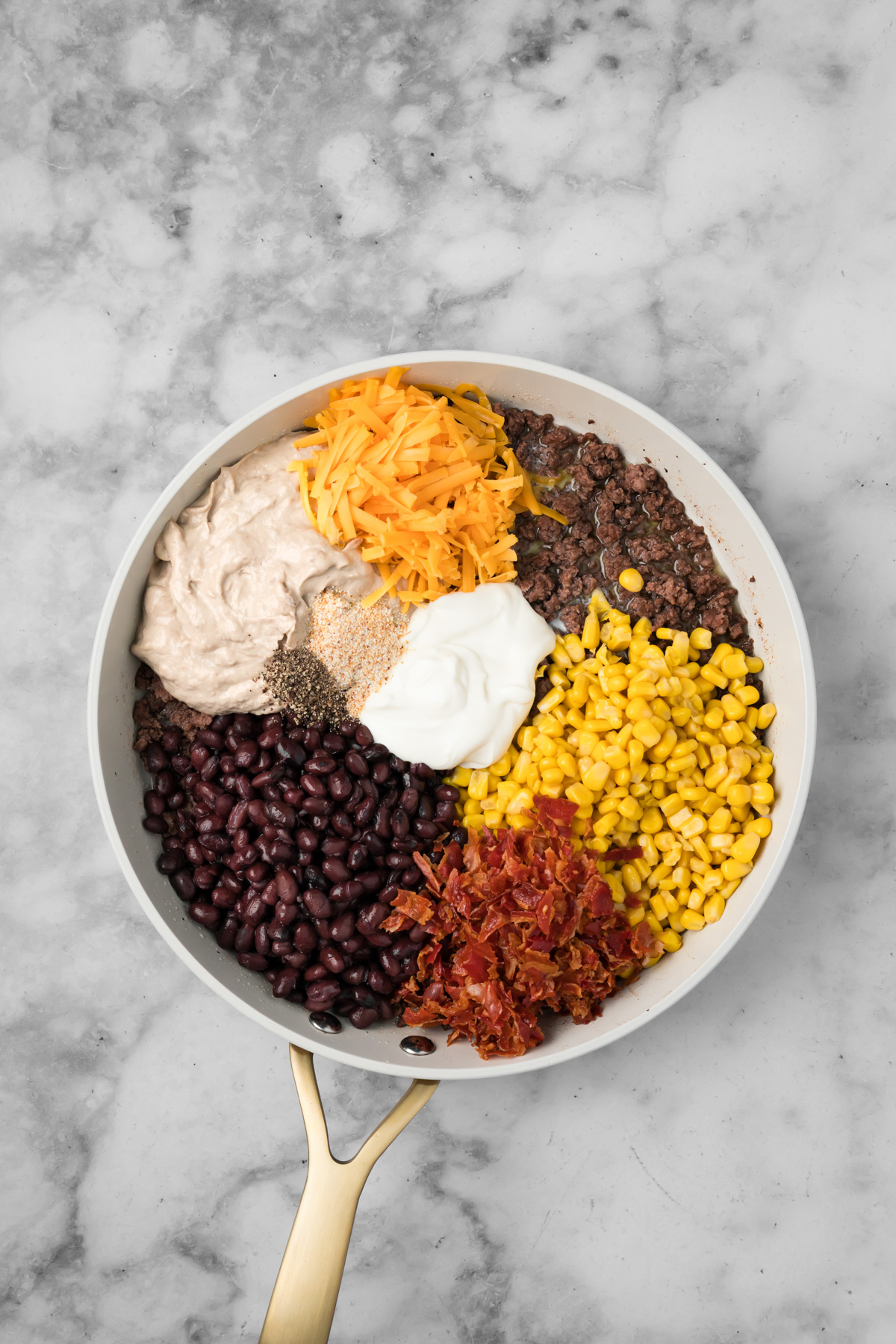 Cowboy casserole ingredients in a pan.