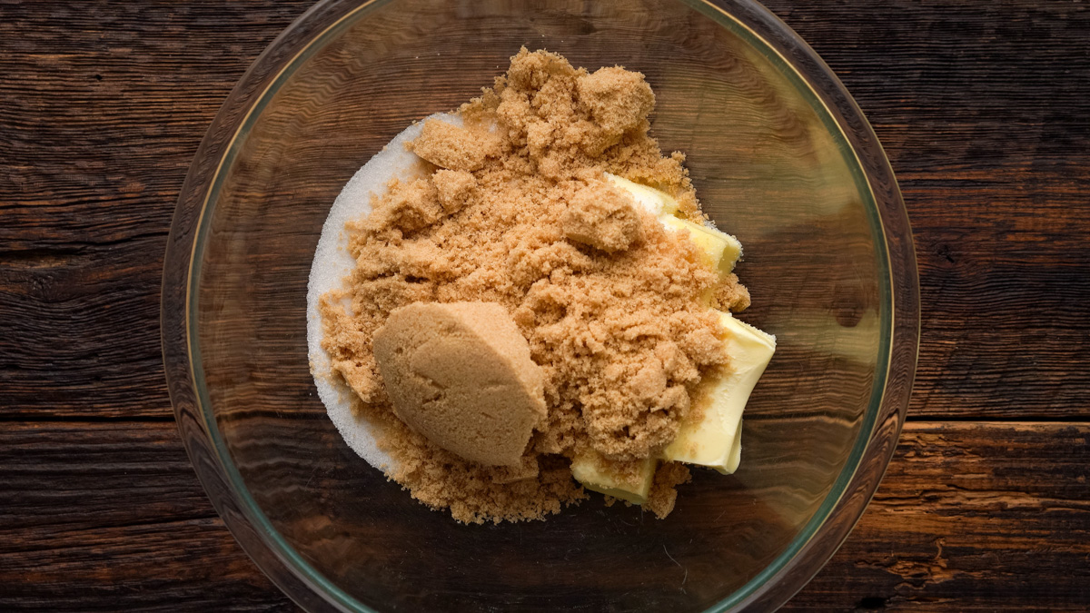 Butter and sugars added into a glass bowl.