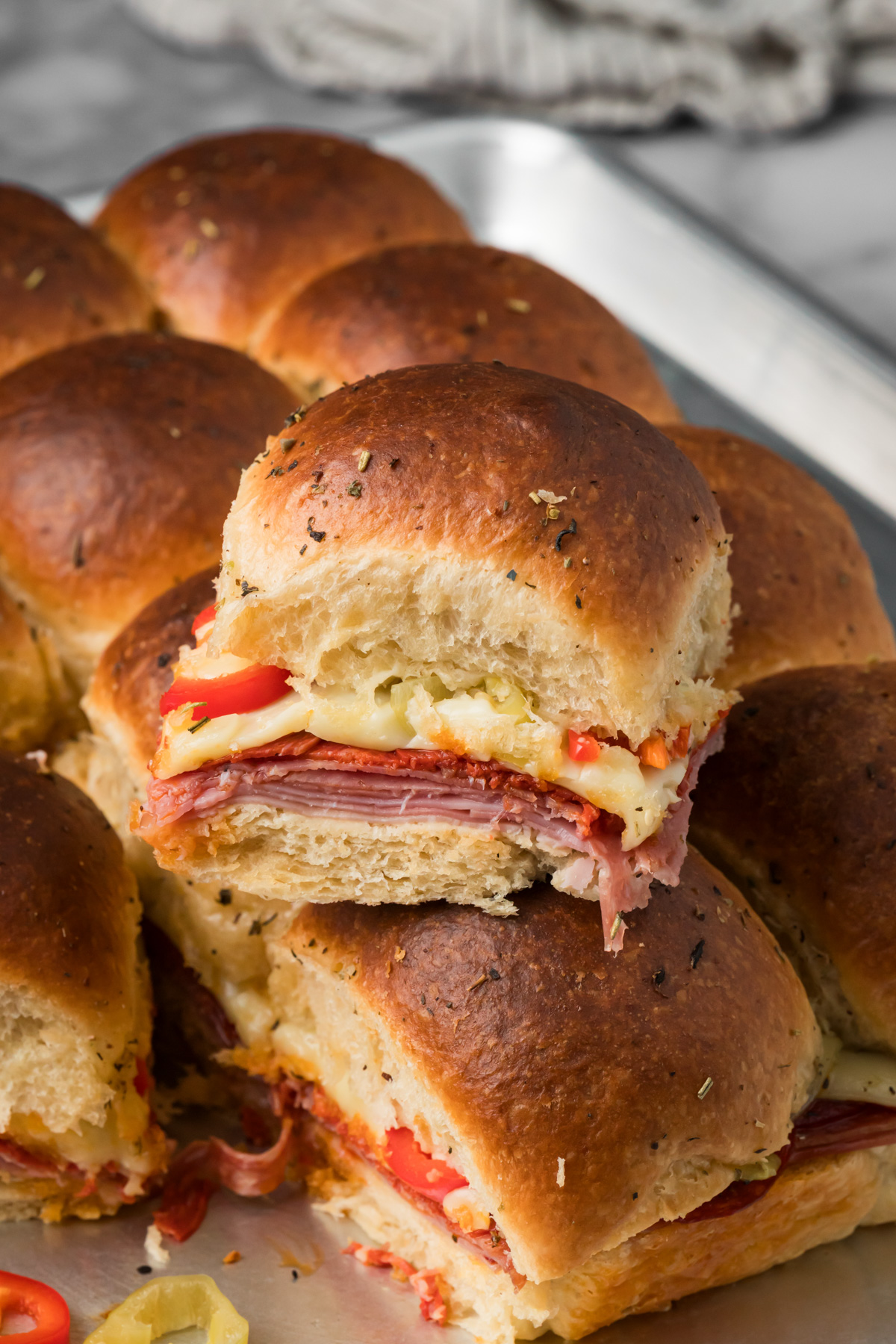 Italian sliders on a baking sheet.