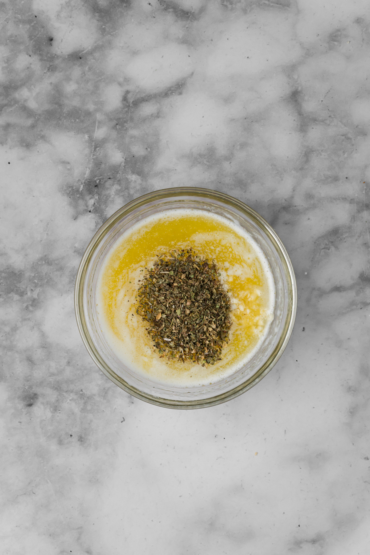 Garlic butter in a glass bowl.