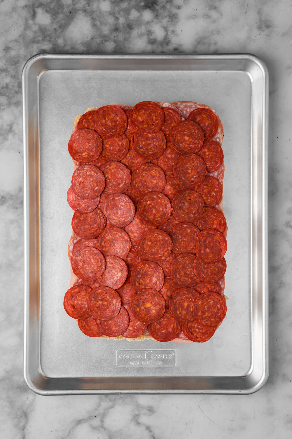 Meat added in layers on top of the buns.
