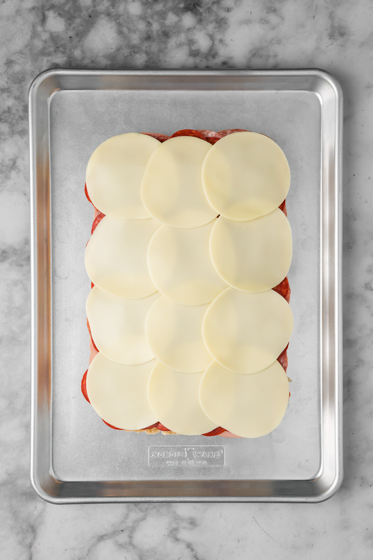 Cheese layered on top of the meat.