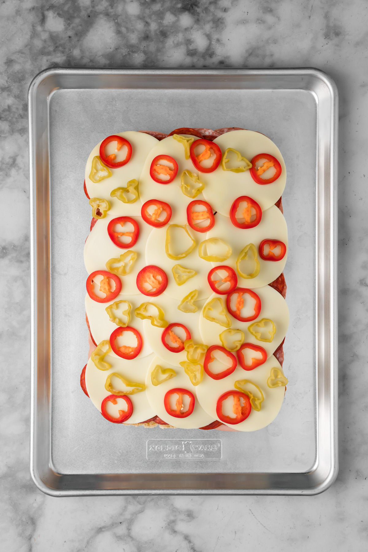 Veggies layered on top of the cheese.