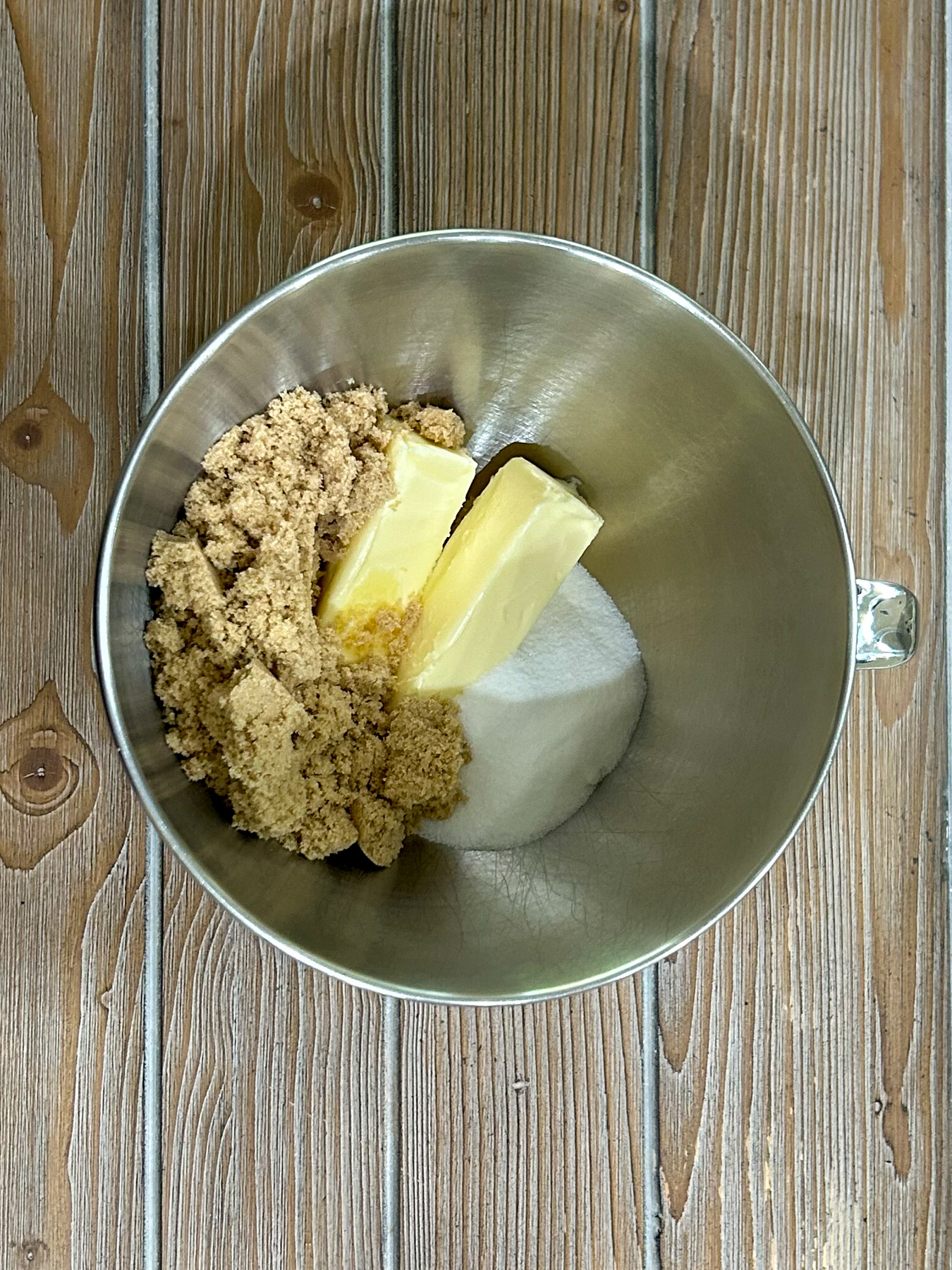 Butter and sugars in a mixing bowl.