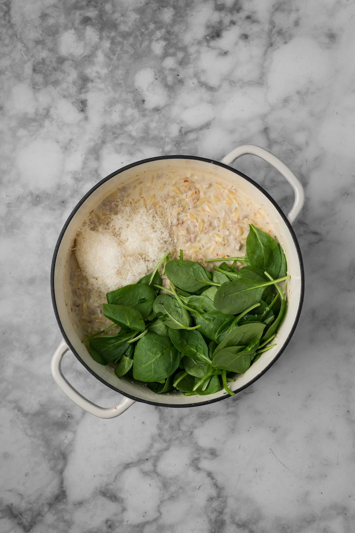 Fresh spinach and parmesan added into the pot.
