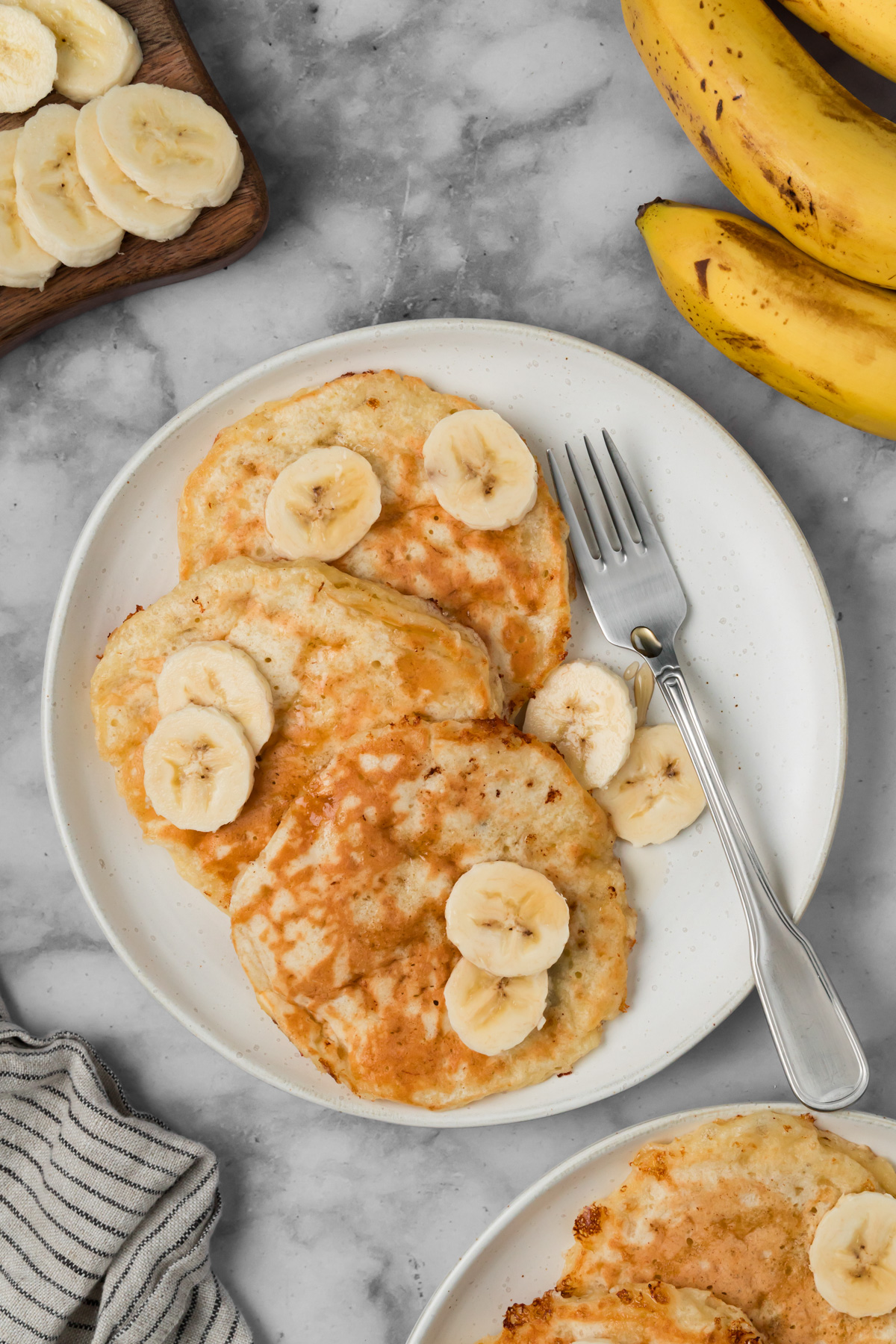Cottage cheese banana pancakes on a white plate.