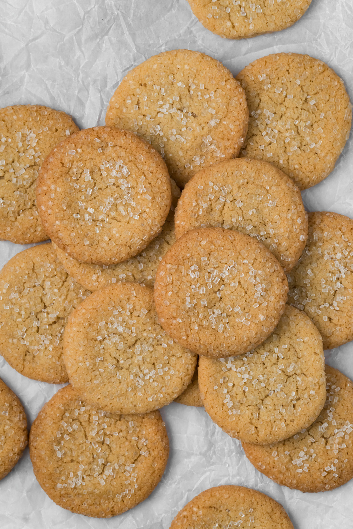 Brown butter sugar cookies on white parchment paper.