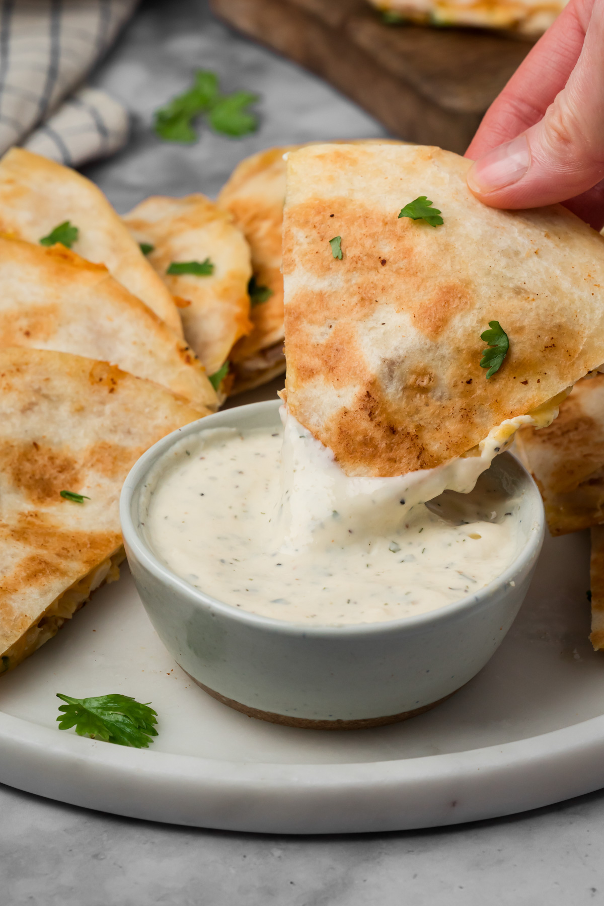 Quesadilla being dipped into ranch.