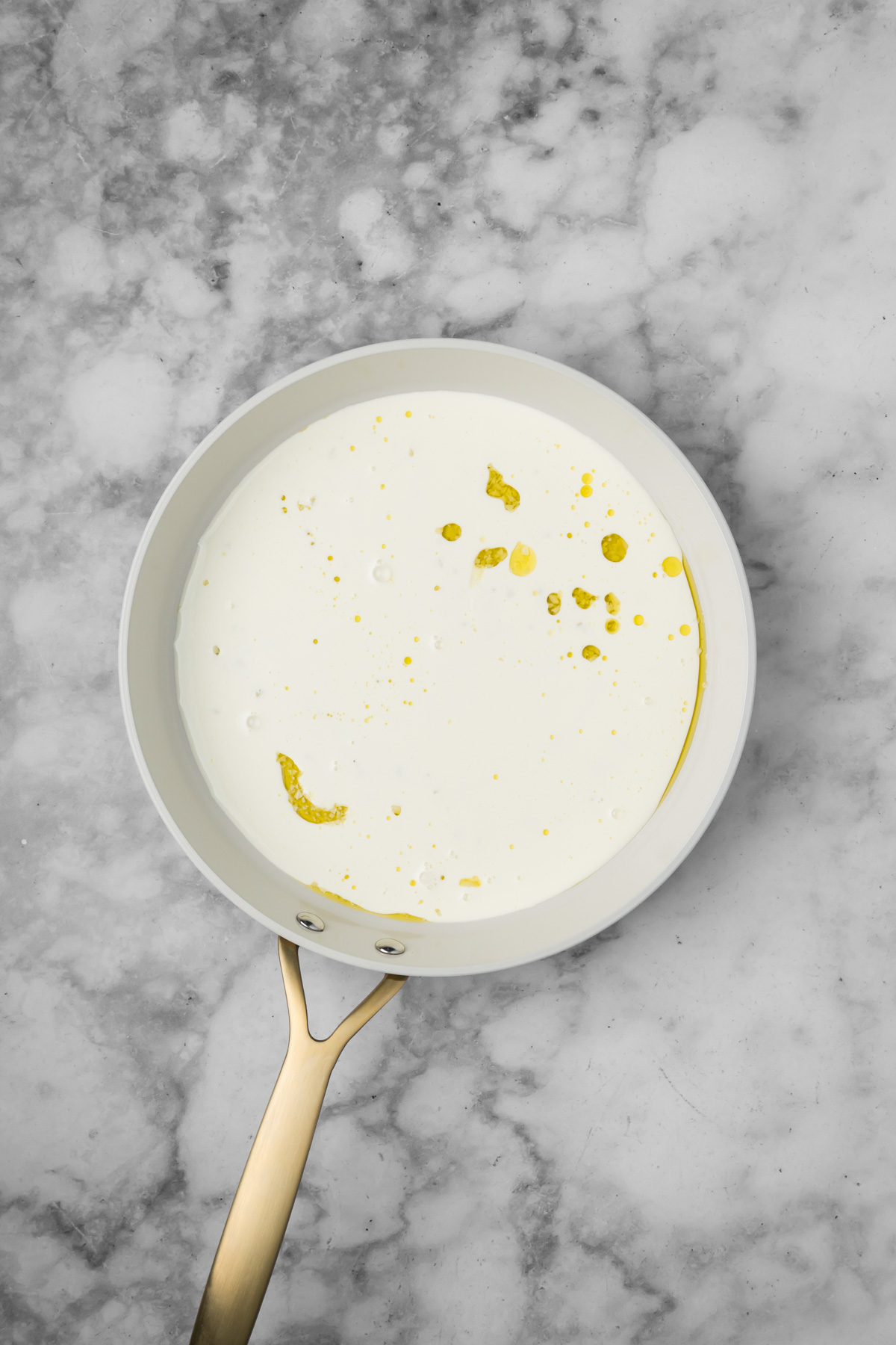 Heavy cream added to the pan.