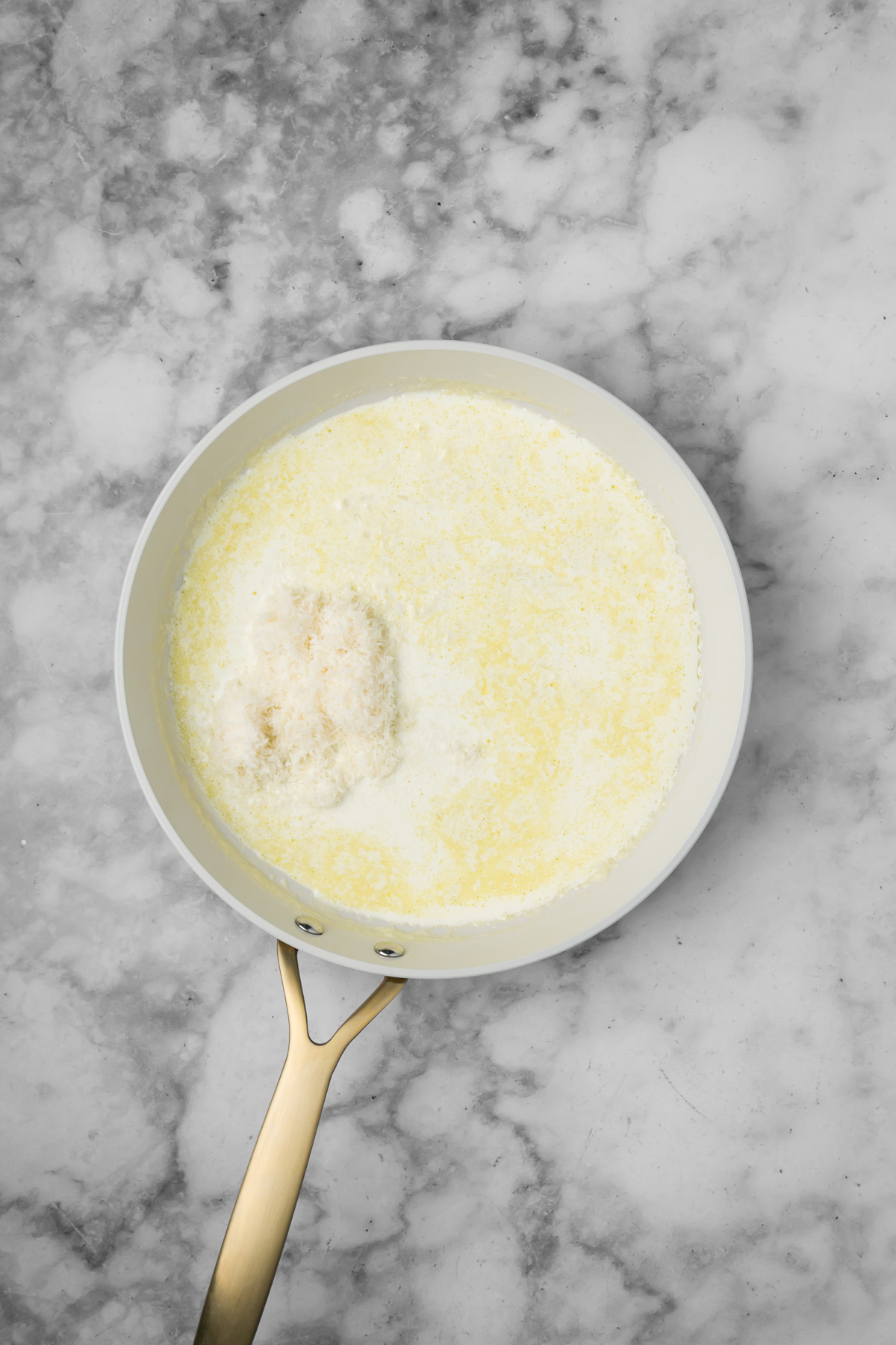 Parmesan cheese added to the pan.