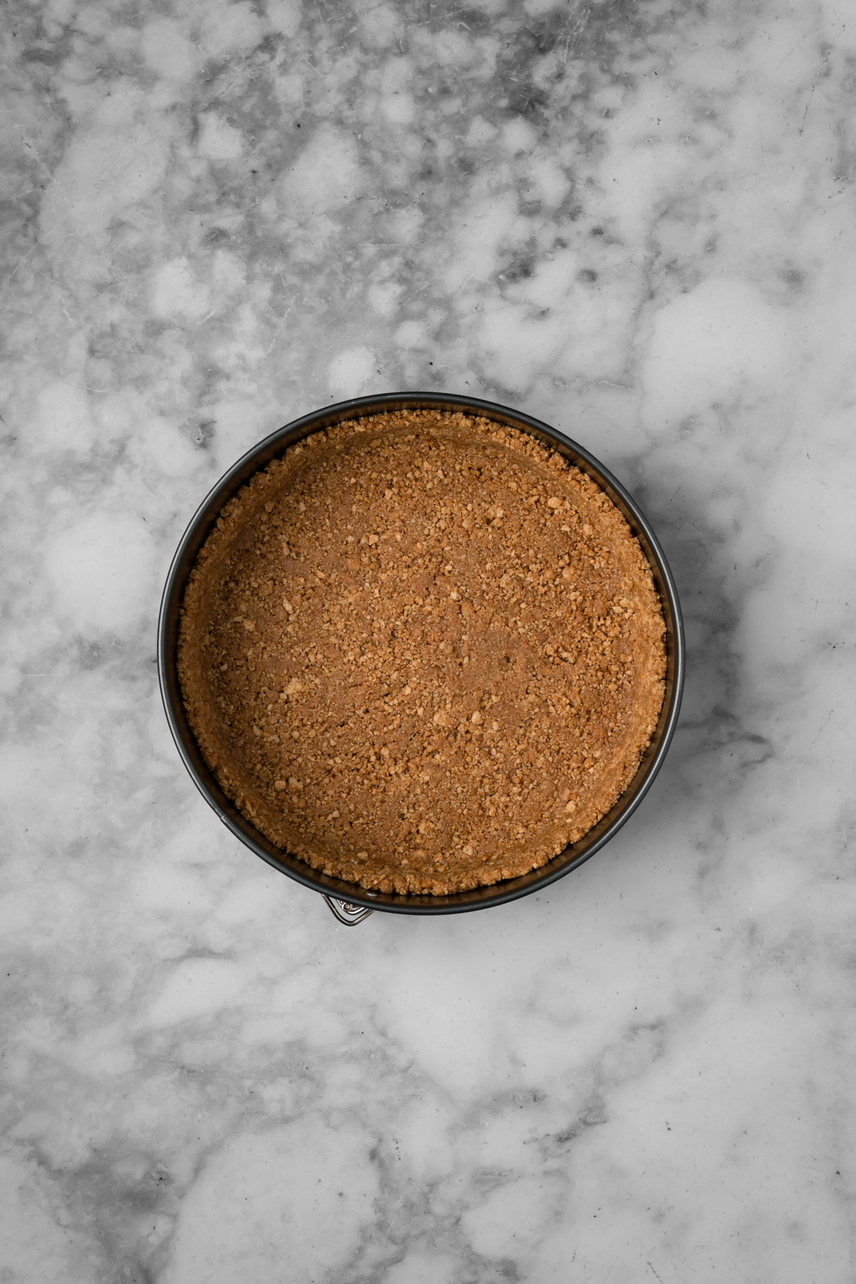Graham cracker crust after it has baked in the springform pan.