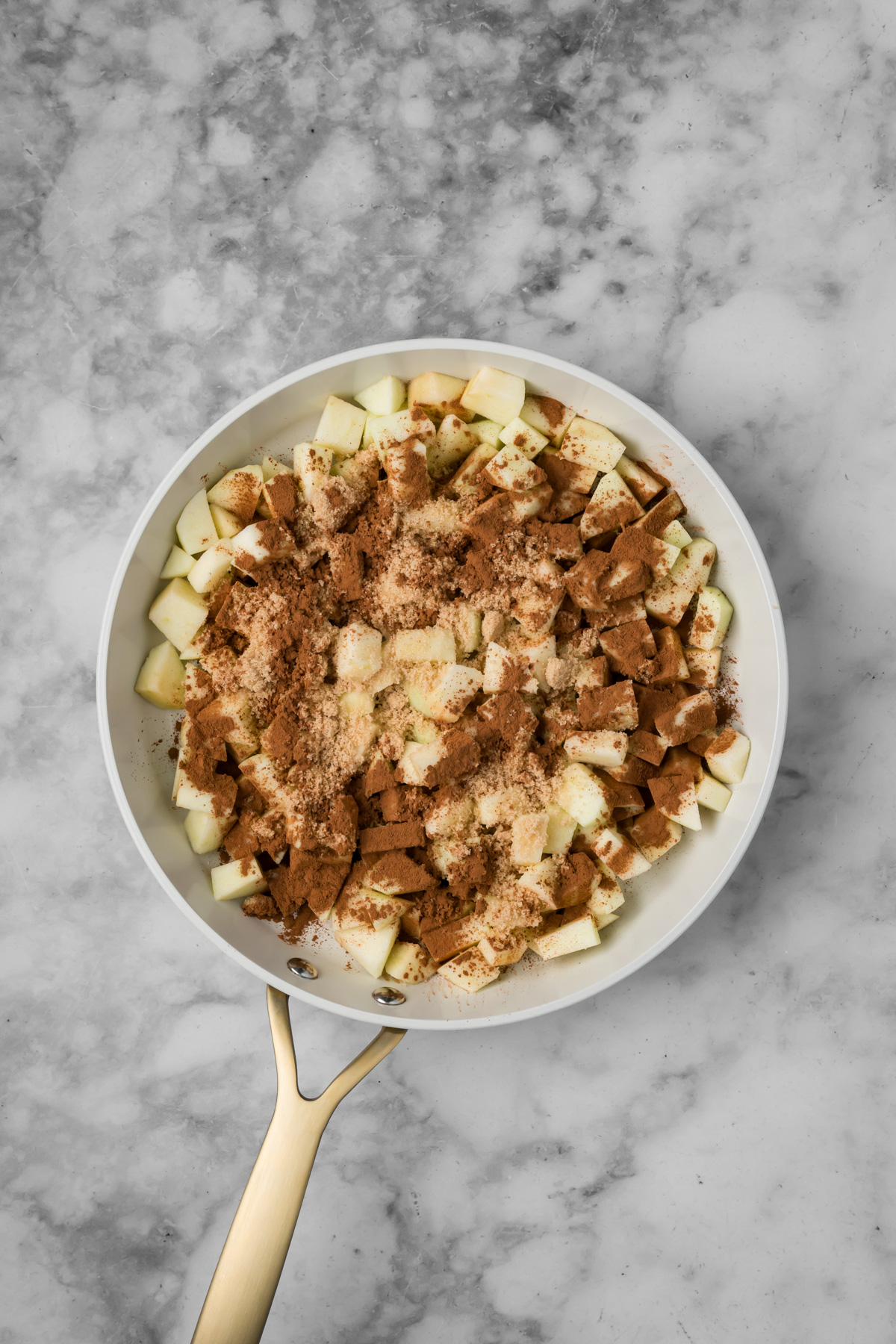 Apple mixture ingredients in a skillet before cooking.