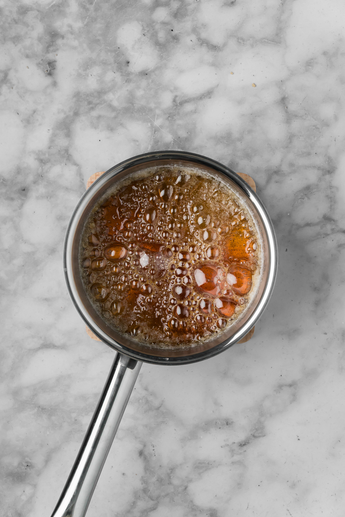 Caramel cooking in a pot.