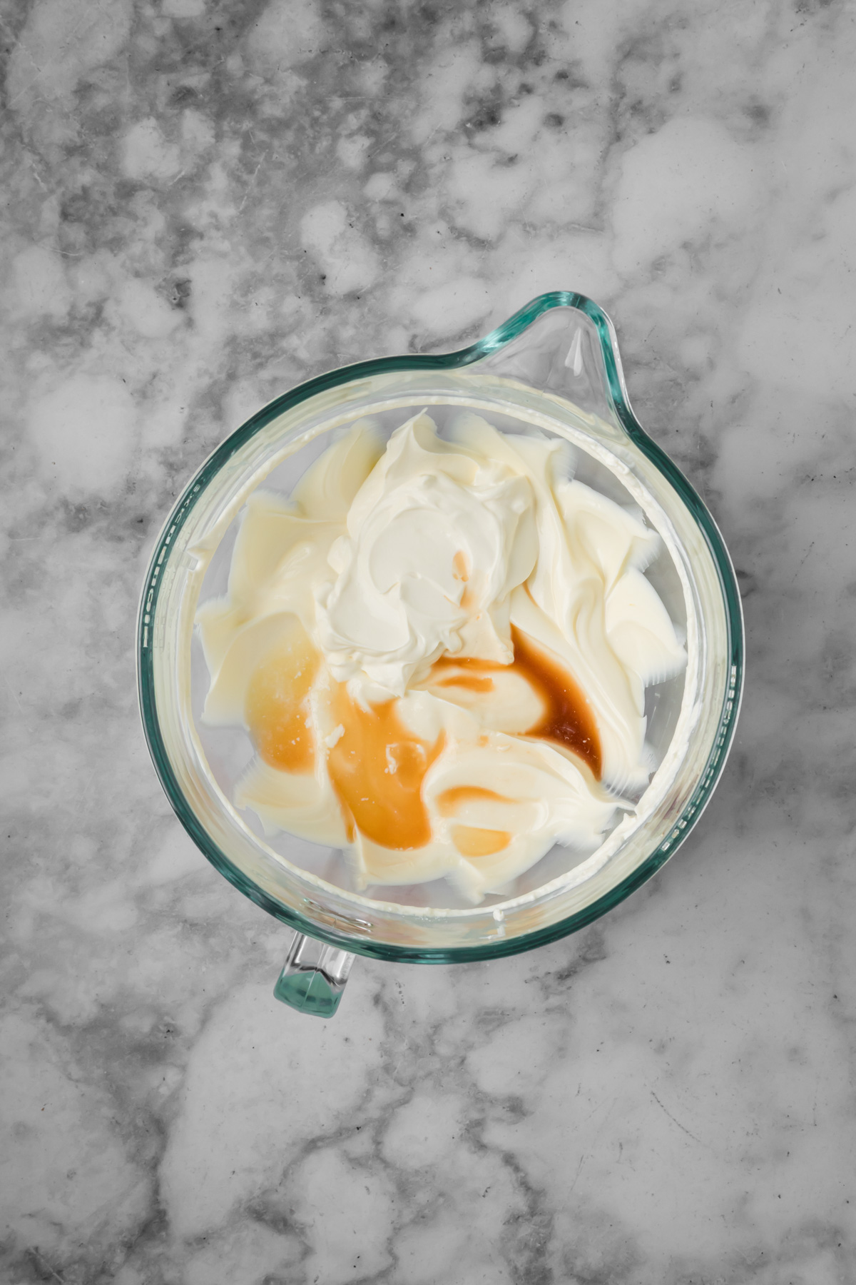 Sour cream, lemon juice, and vanilla added to the cream cheese mixture.