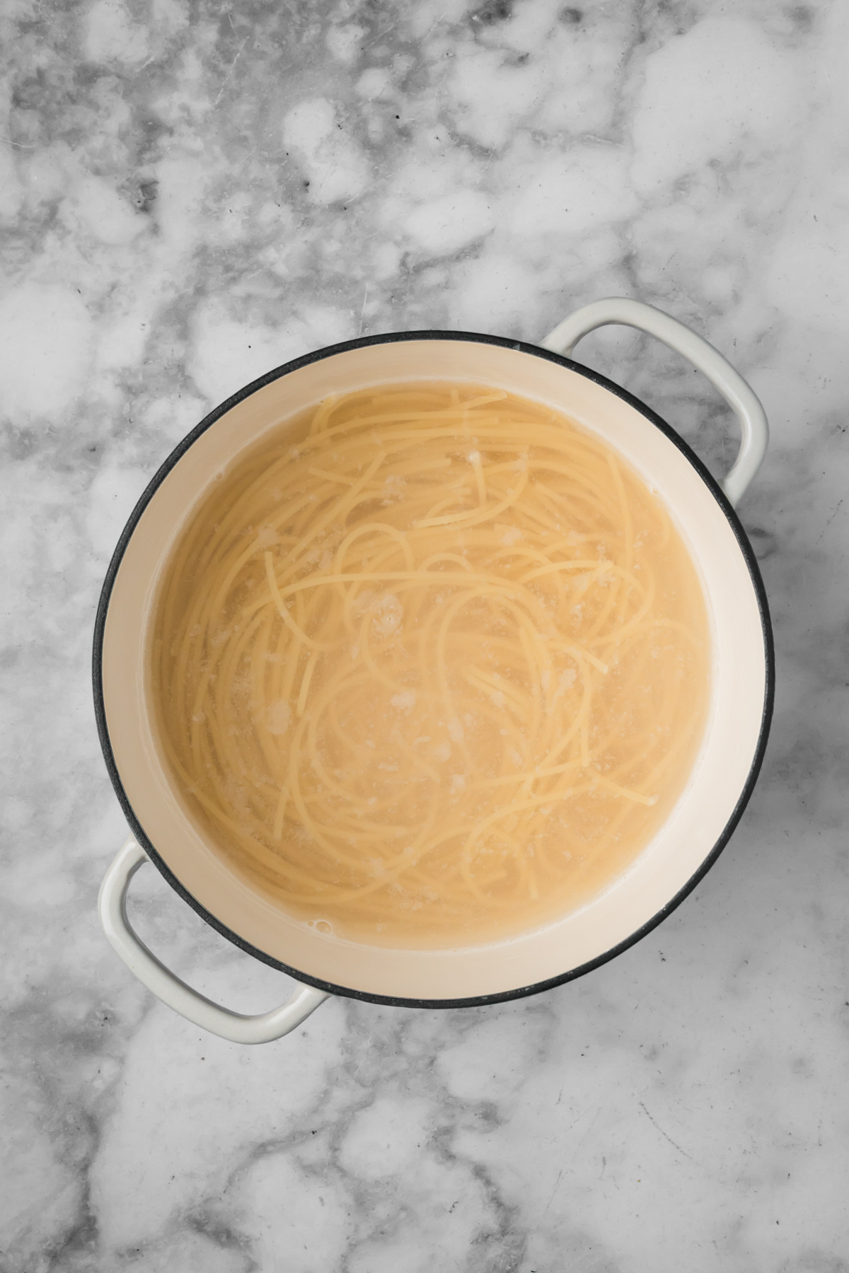 Spaghetti cooking in a pot.