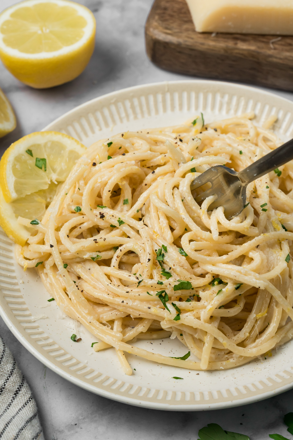 Fork twirling some spaghetti with lemon cream sauce.