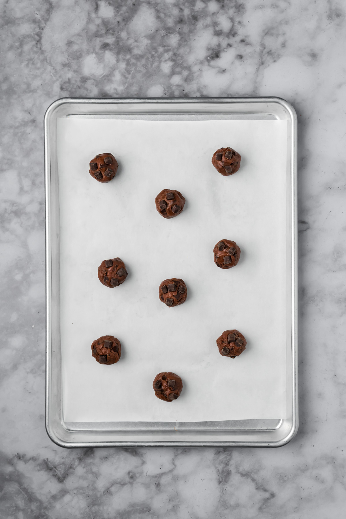 Extra chocolate chunks added on top of the cookie dough balls before baking.