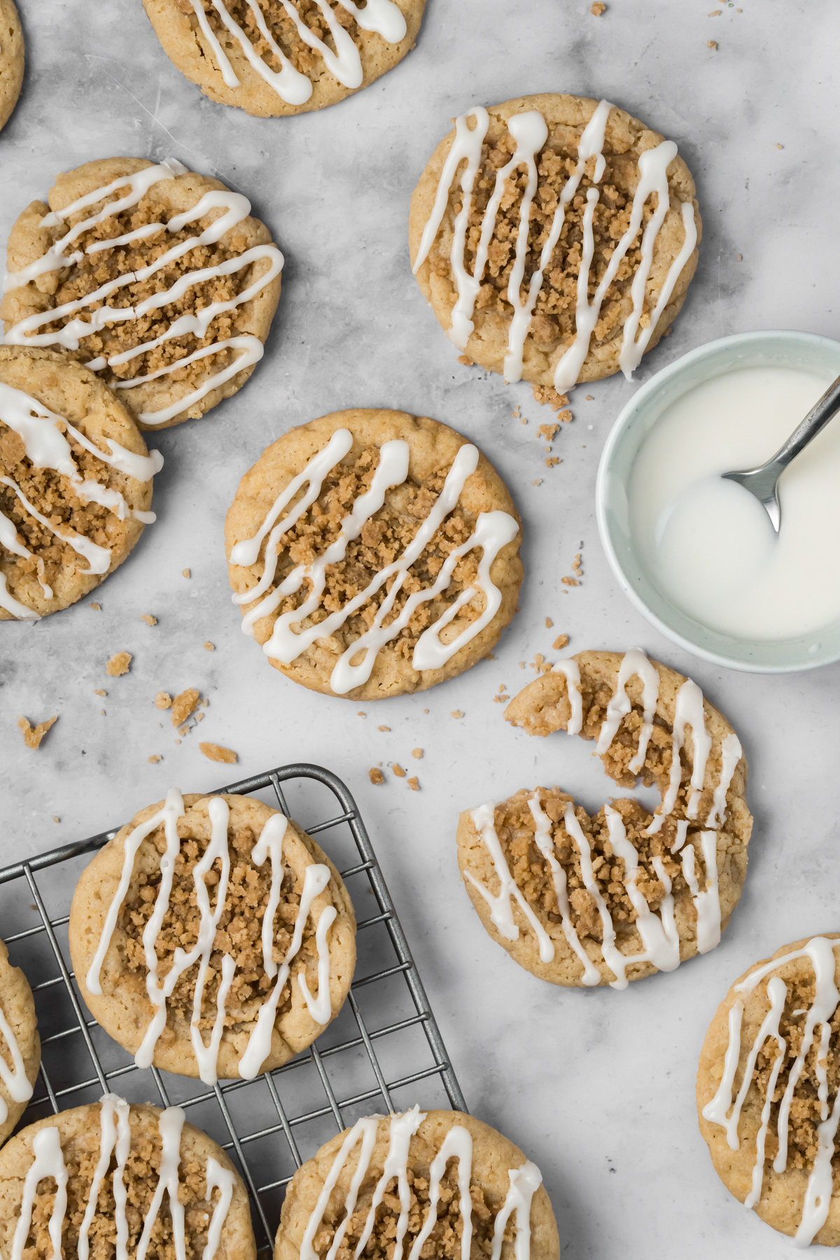 Coffee cake cookies with a bowl of frosting on the side.