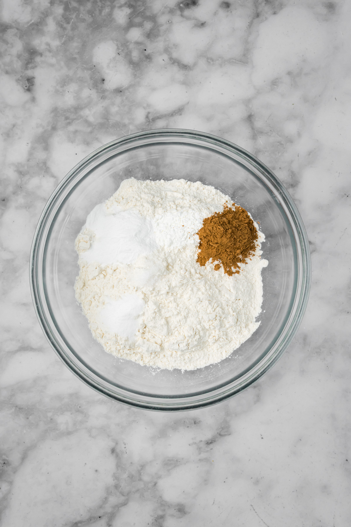 Dry ingredients in a glass bowl before mixing.