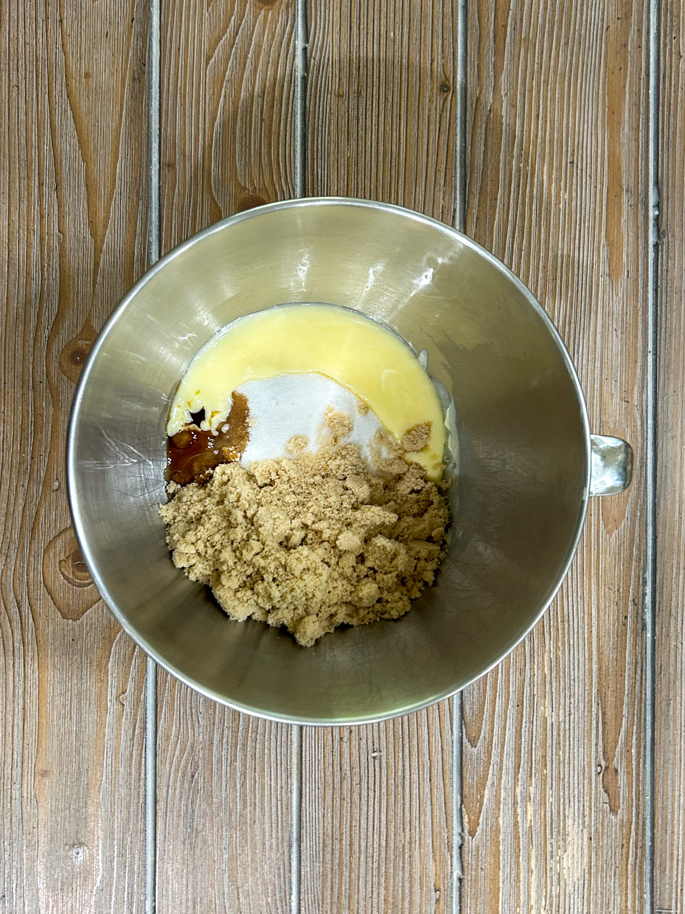 Butter, sugars, and vanilla in a bowl.