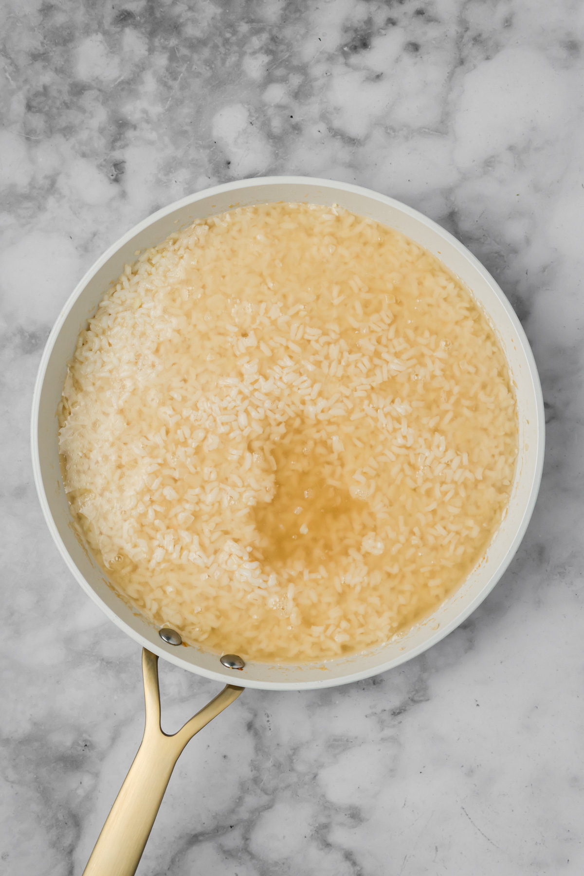 Chicken stock added to the risotto. 