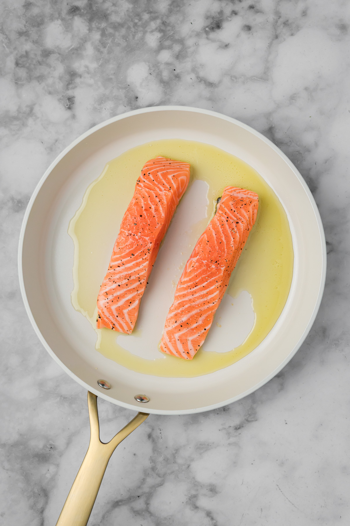 Salmon cooking in a skillet. 