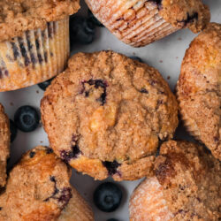 Skip the bakery line and enjoy these homemade Bakery Style Blueberry Muffins right at home! Fluffy muffins packed with juicy blueberries and topped with a sweet crumble.