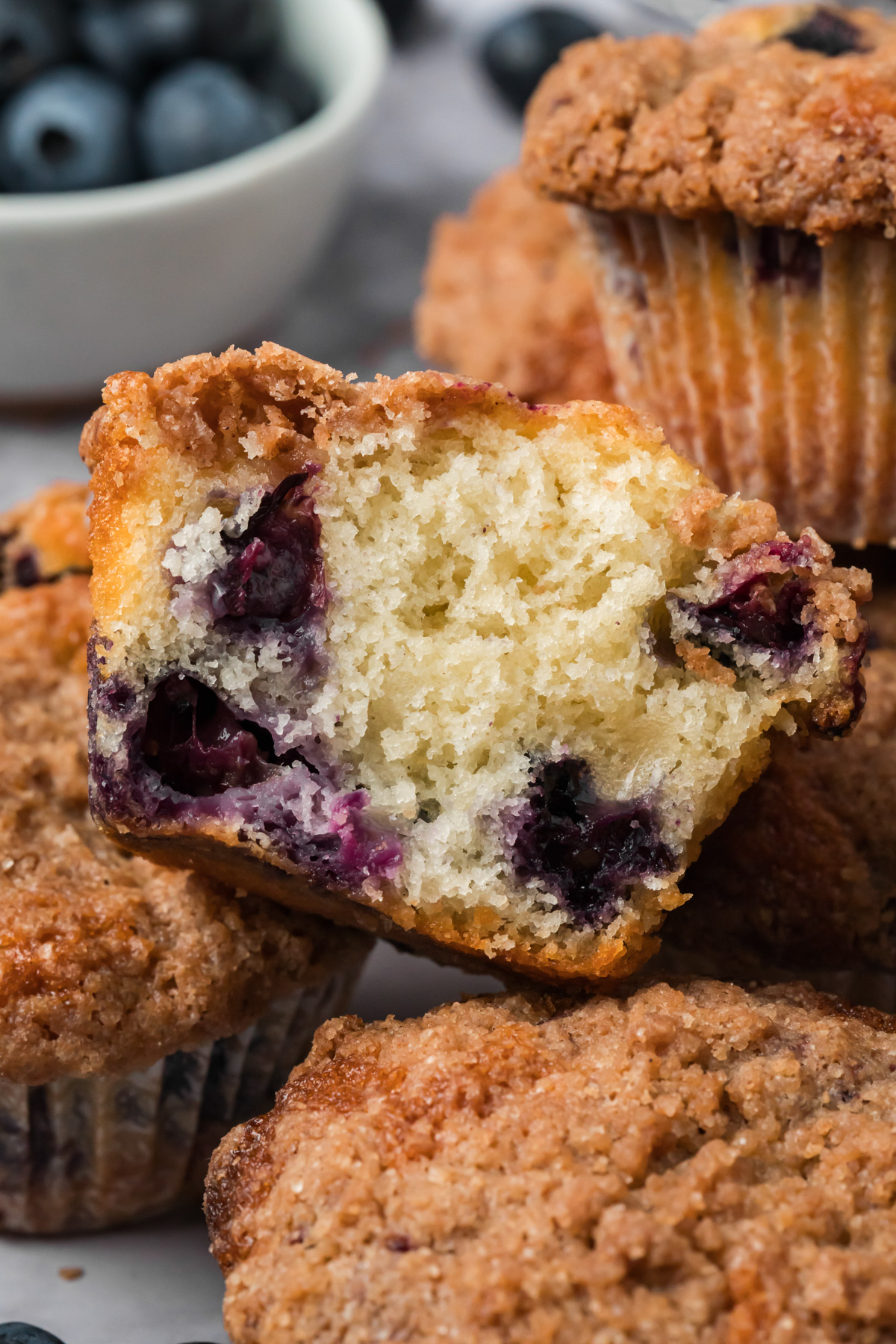 Blueberry muffin cut in half showing the fluffy inside.