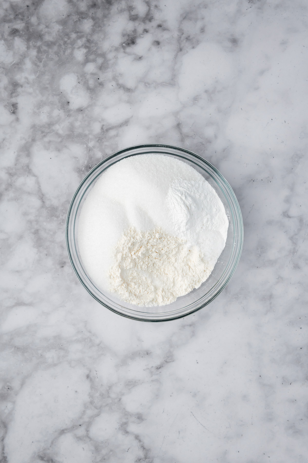 Dry muffin ingredients in a glass bowl. 