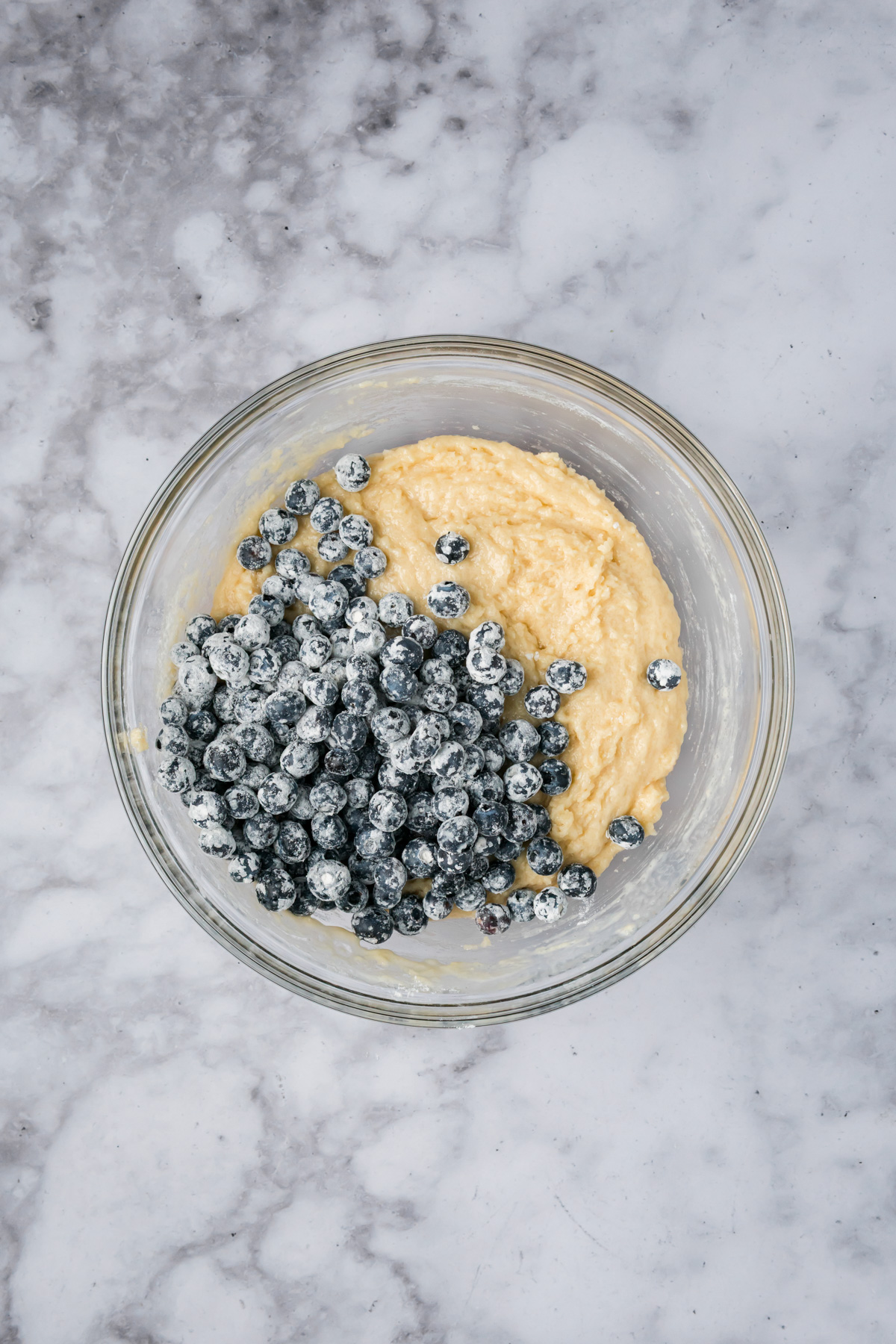 Floured blueberries added to the muffin batter.