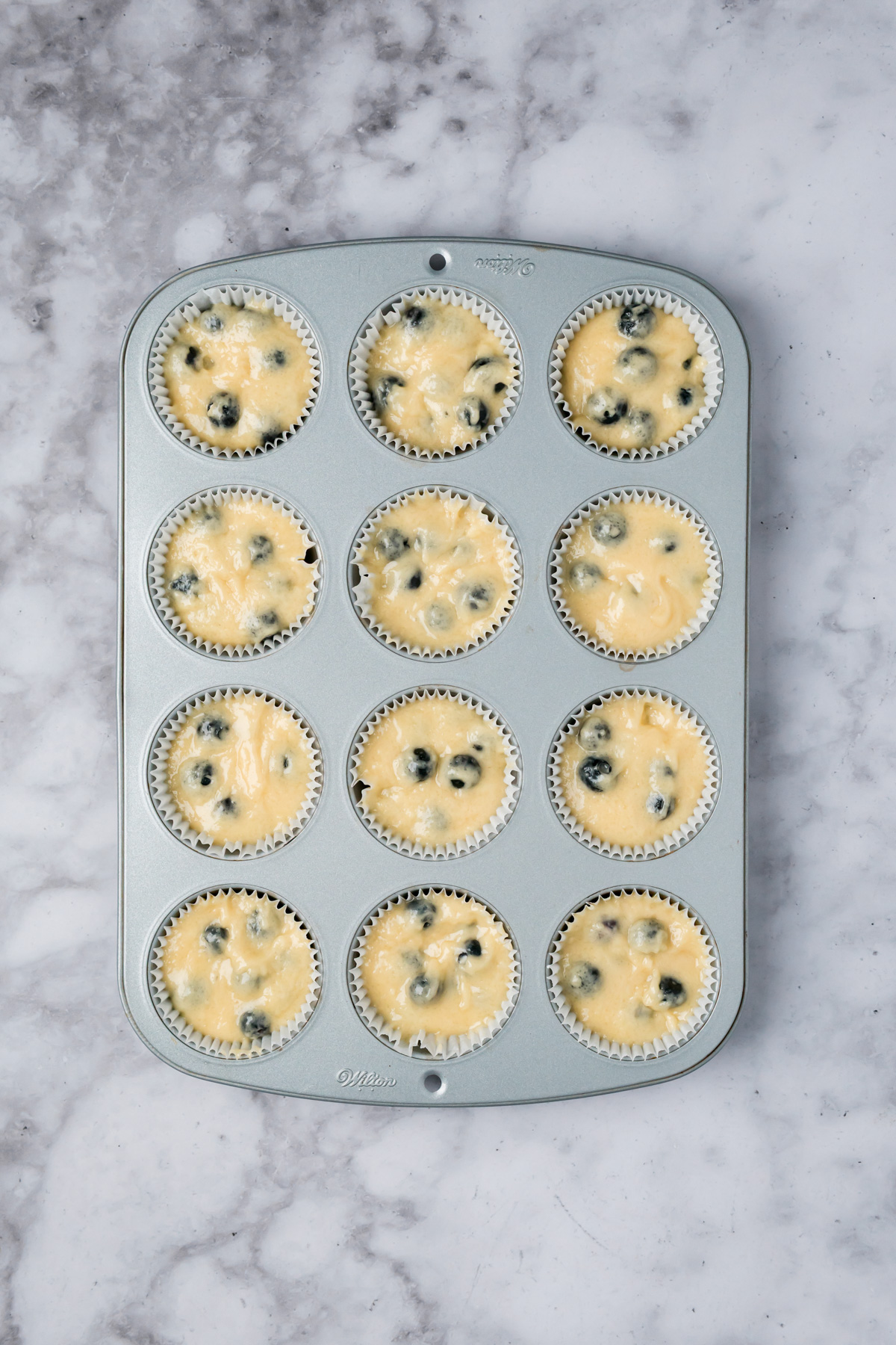 Muffin batter added to the muffin tin.