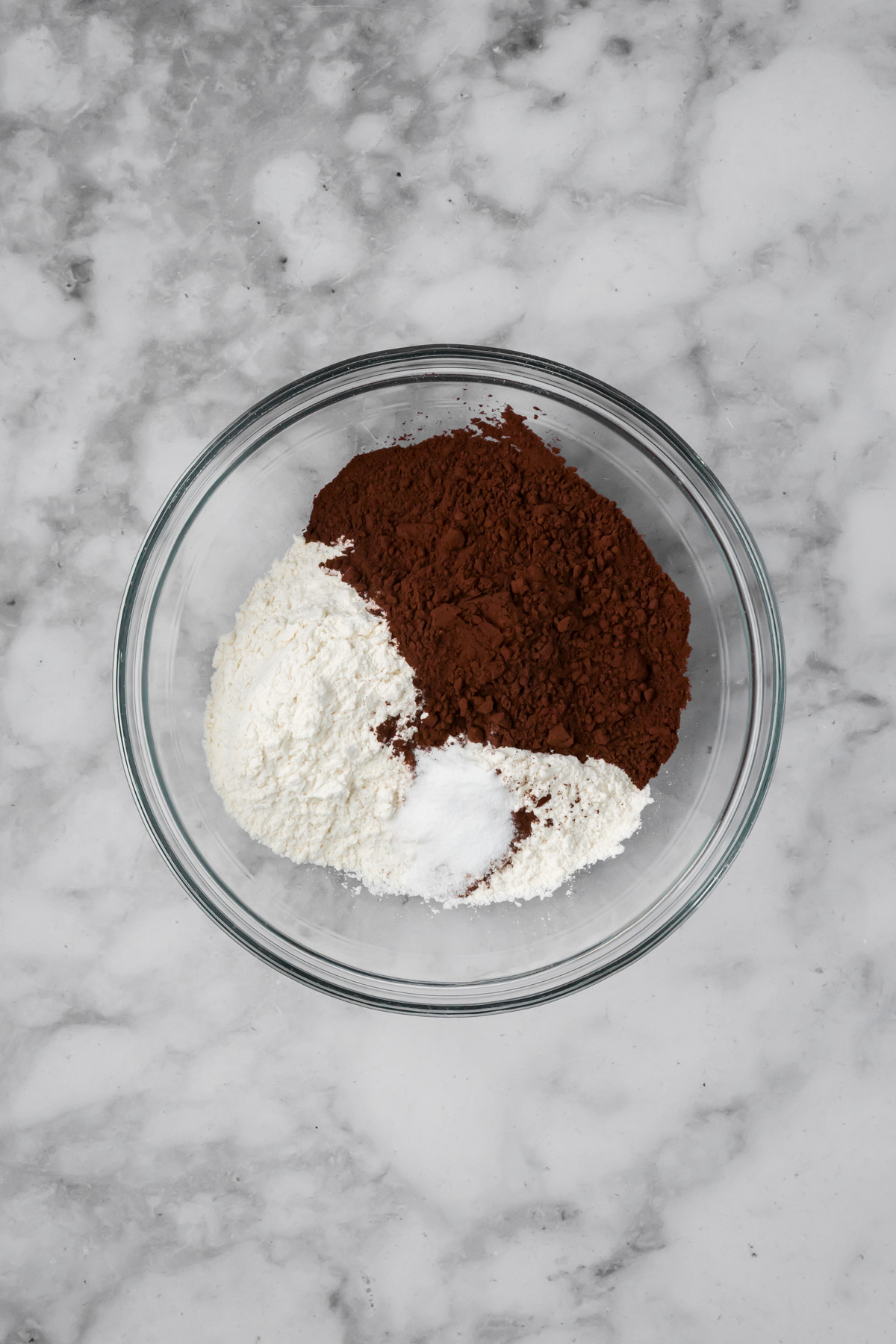 Dry ingredients for the black forest cookies in a glass bowl.