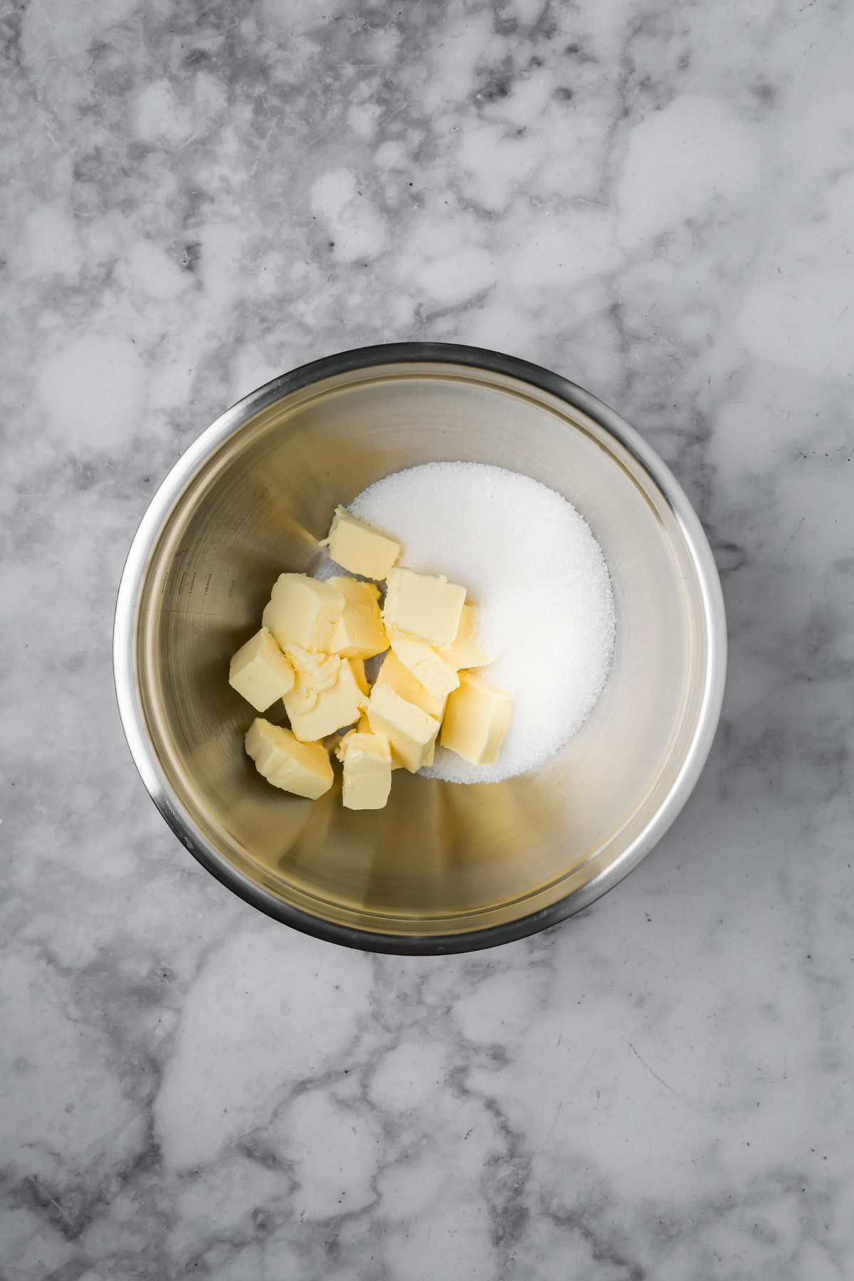 Butter and sugar in a bowl.